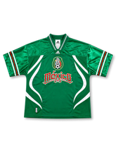 メキシコ代表ブリングバックリミックスジャージ、グリーンボディ、白カーブパネル、代表エンブレム、Méxicoロゴ、幾何学柄Vネック、袖口トリコロールライン、前面と背面